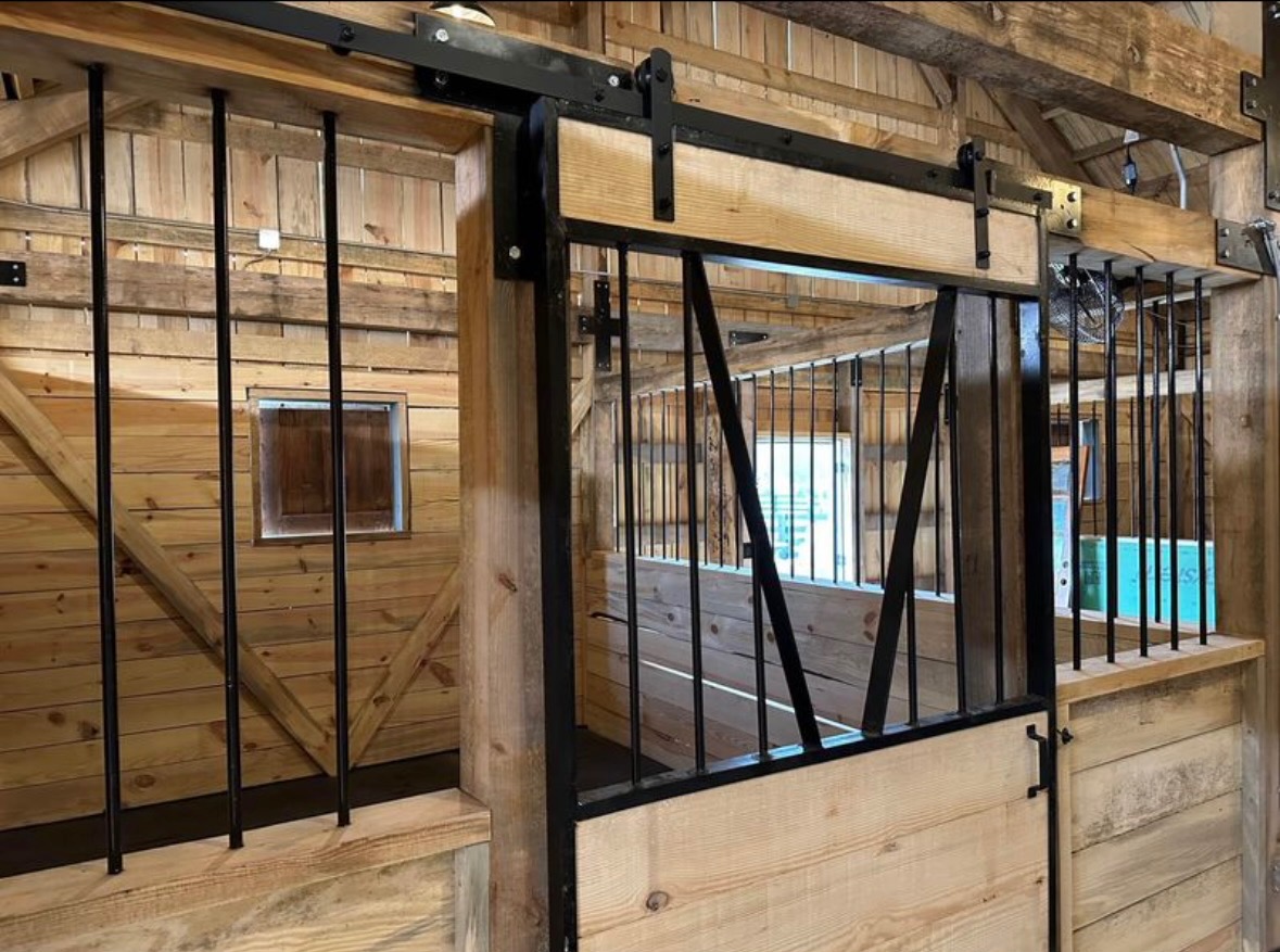 Interior horse stall with steel grille sliding door