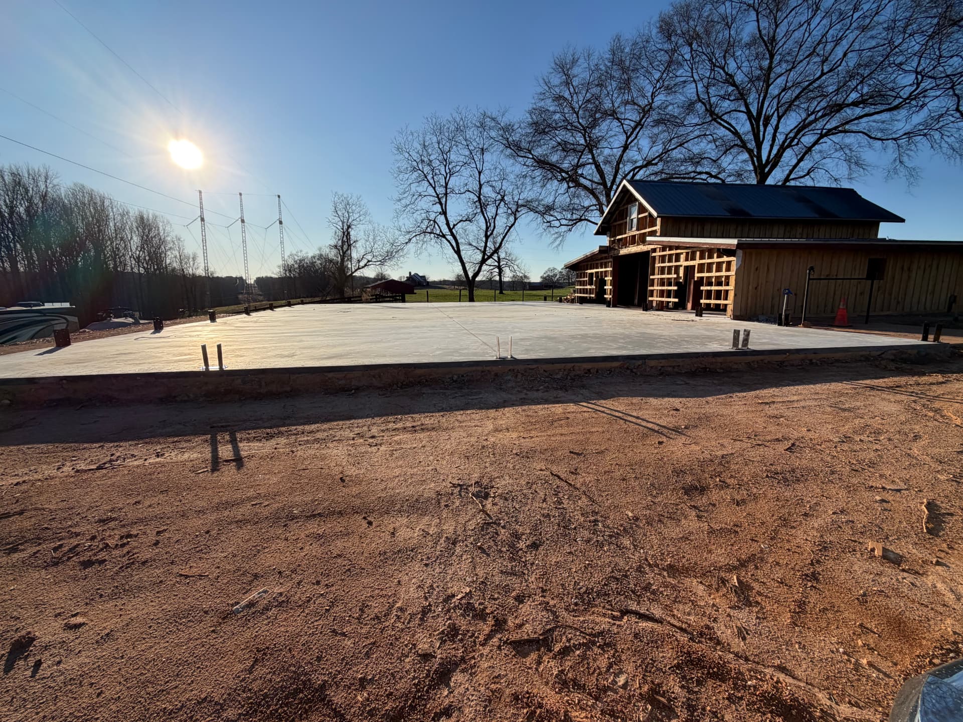 Barn build in progress with concrete slab and timber framing